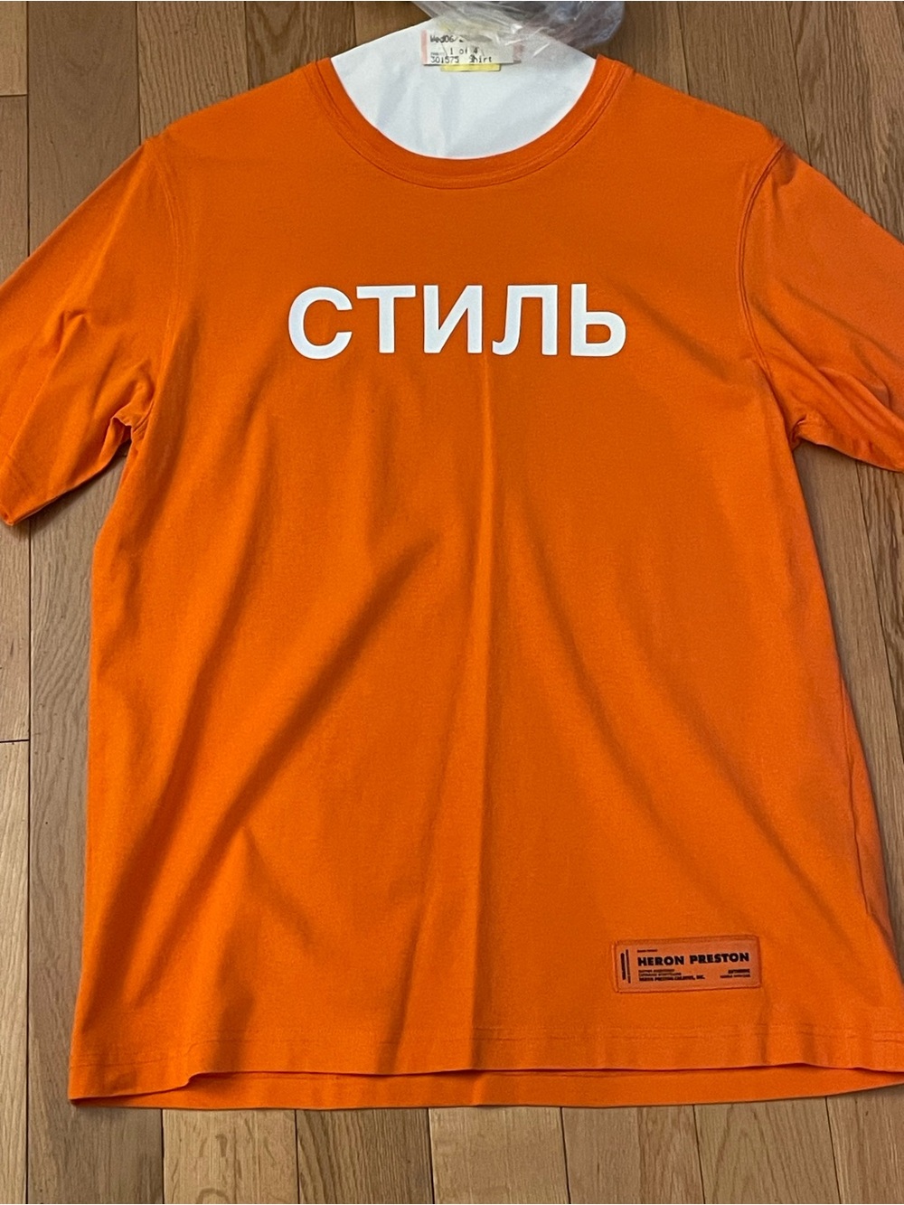 Heron Preston Orange Tee with White 'СТИЛЬ' Graphic
